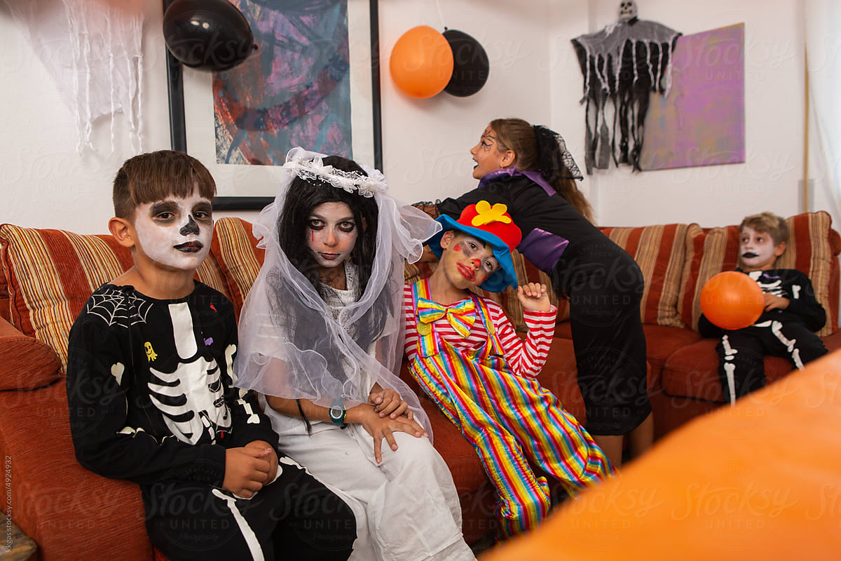 five children in fancy dress waiting for halloween party
