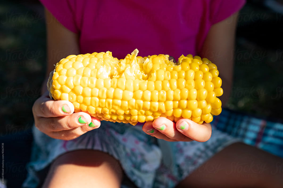 Child holding  corn cob