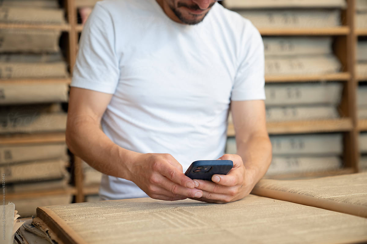 Man Using Phone In Archive