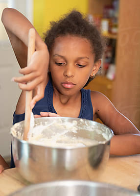 Young Girl Pouring Frozen Fruit Into A Blender by Stocksy Contributor  Anya Brewley Schultheiss - Stocksy