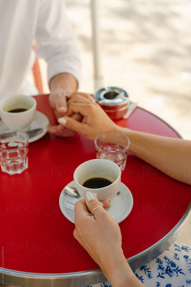 close up of hands  having coffee in Paris