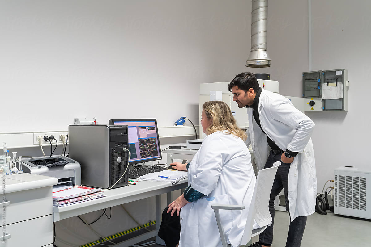 Two Researchers Working Together In The Lab