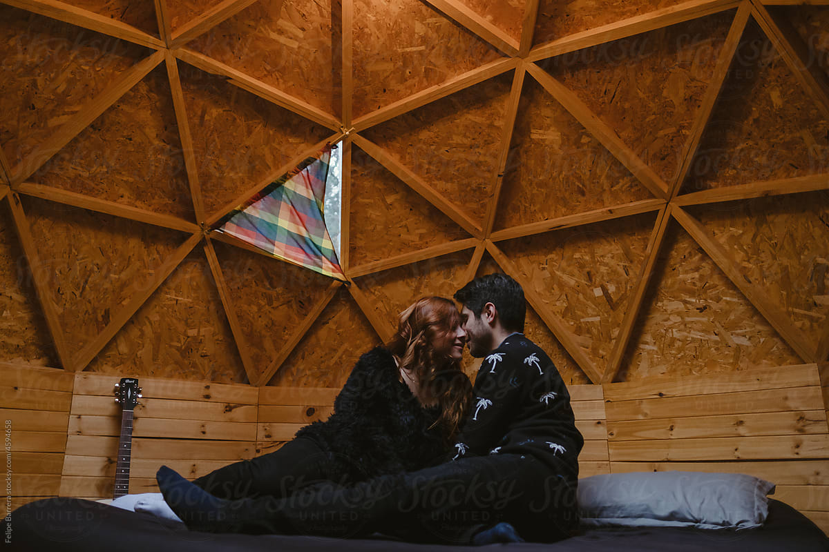 Beautiful couple looks at each other in a glamping