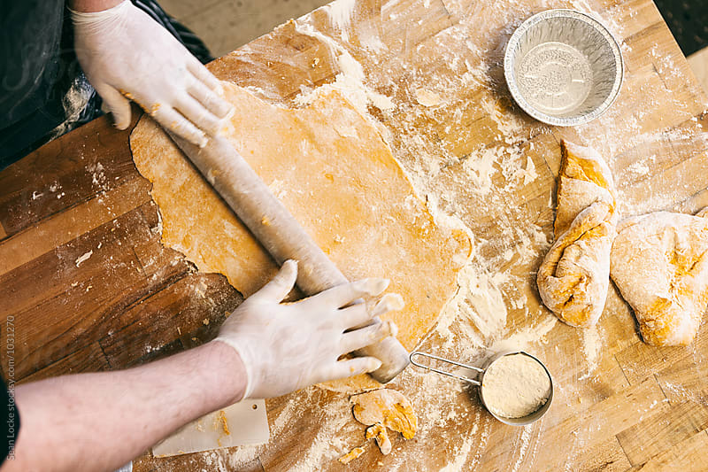 Bakery: Male Baker Rolls Out Dough For Quiche Crusts