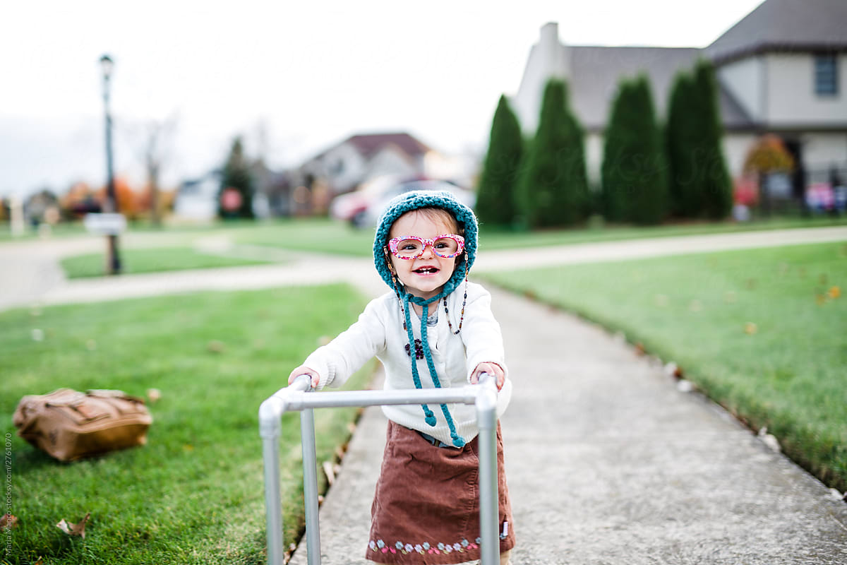 Toddler Girl Dresses Up As Old Lady With Walker For Halloween" by Stocksy  Contributor "Maria Manco" - Stocksy