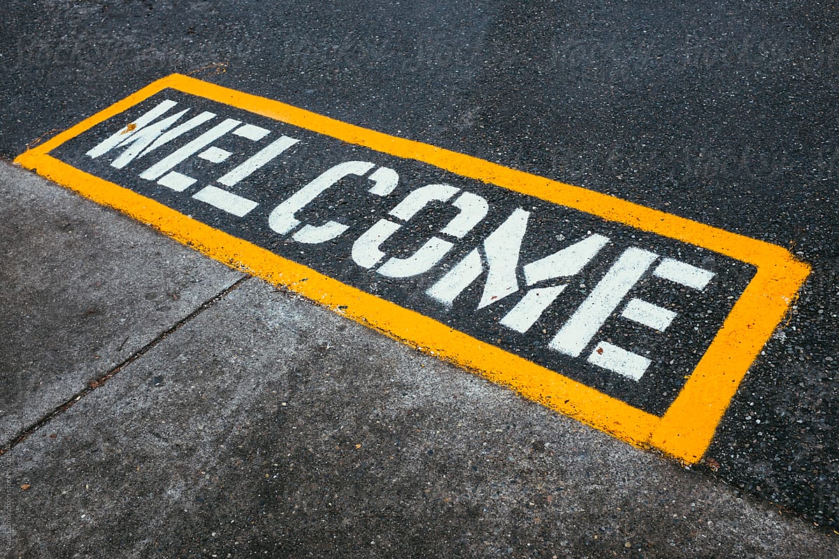 The word WELCOME painted on urban street
