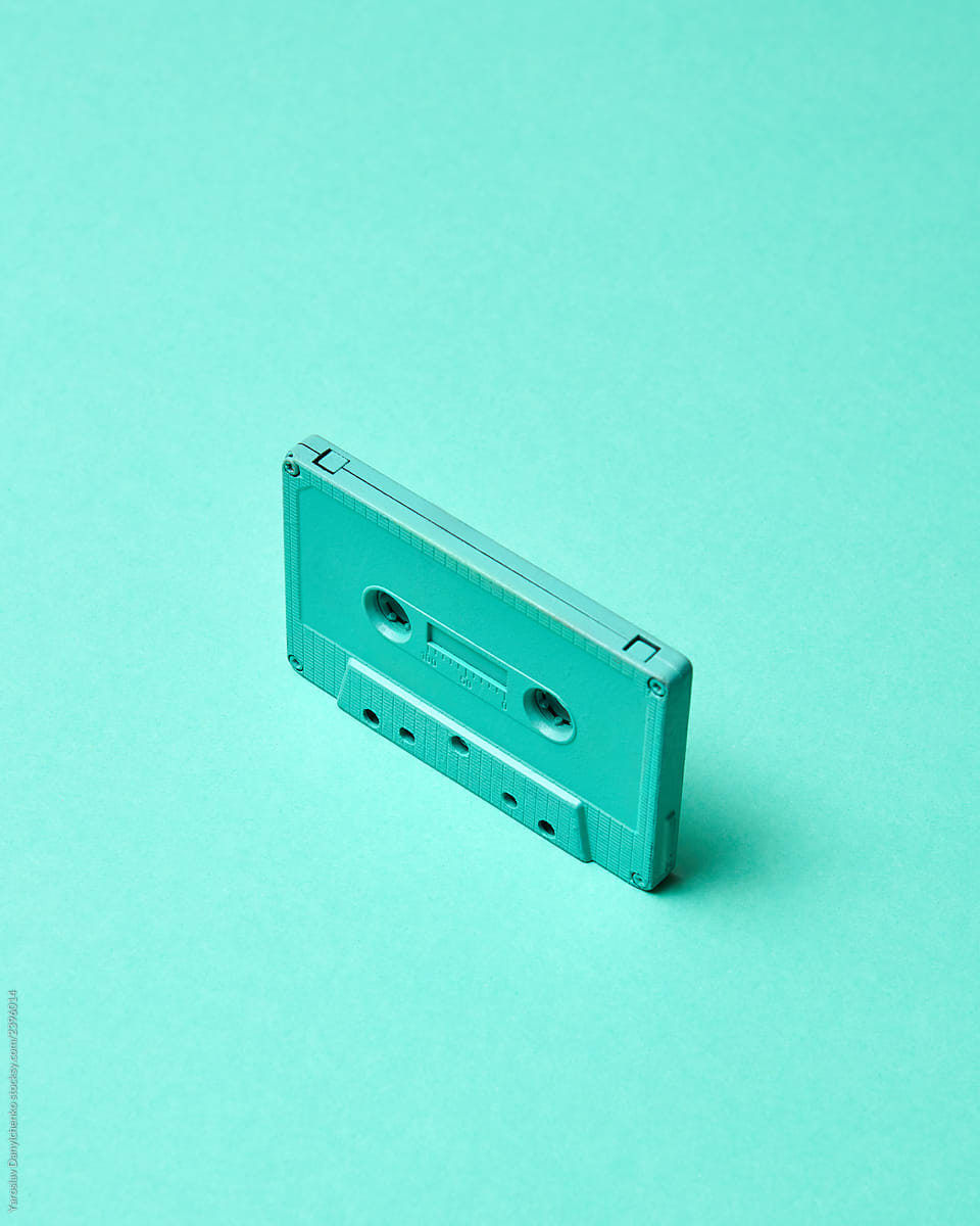 Retro vintage audio tipe cassette on turquoise color pantone background with copy space.