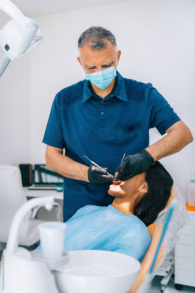 Dentist treating female patient