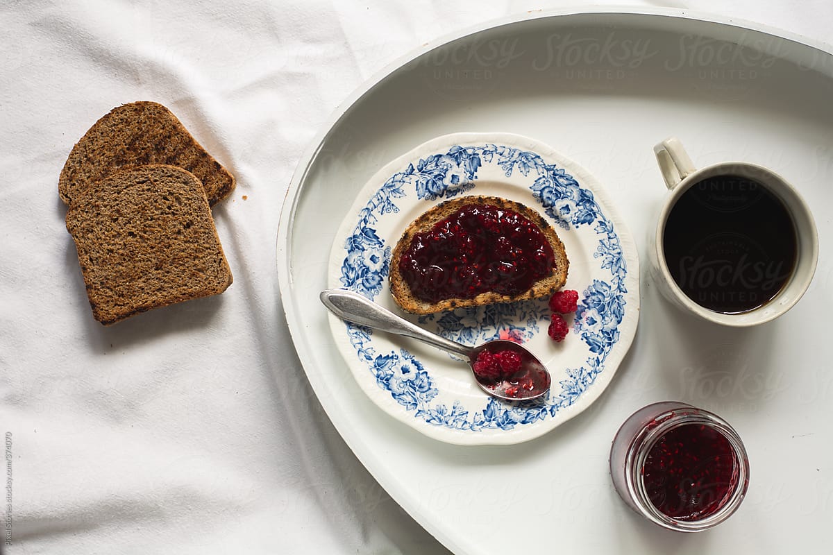 Food: simple breakfast with toasts, raspberry jam and coffee