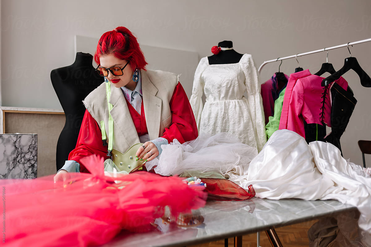 Redhead Dressmaker Working In A Sewing Atelier