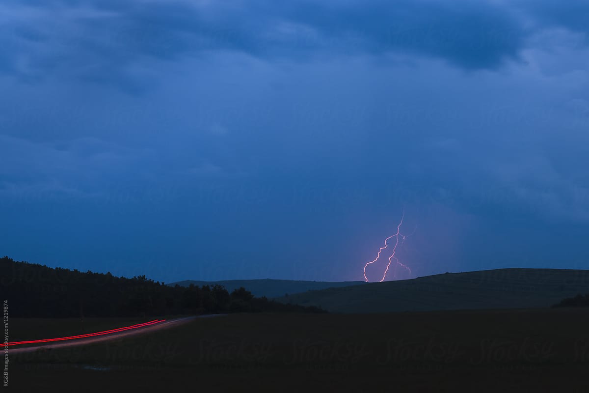 Nature scenery in the twilight with thunderbolt on horizon