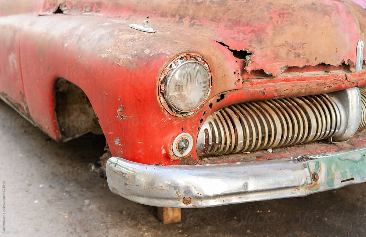 Close Up Of Abandoned Vintage Red Car Headlight