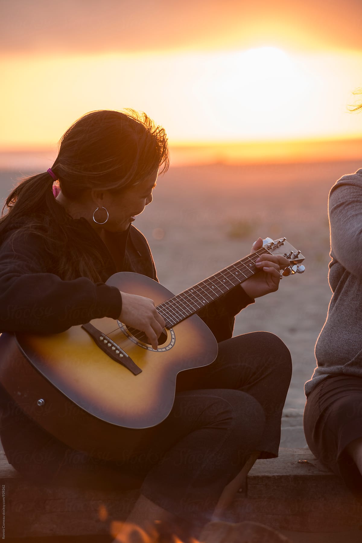 Woman Playing Guitar At The Beach At Sunset By Stocksy Contributor