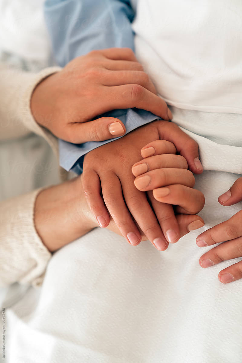 Mother And Daughter Holding Hands In A Hospital By Stocksy