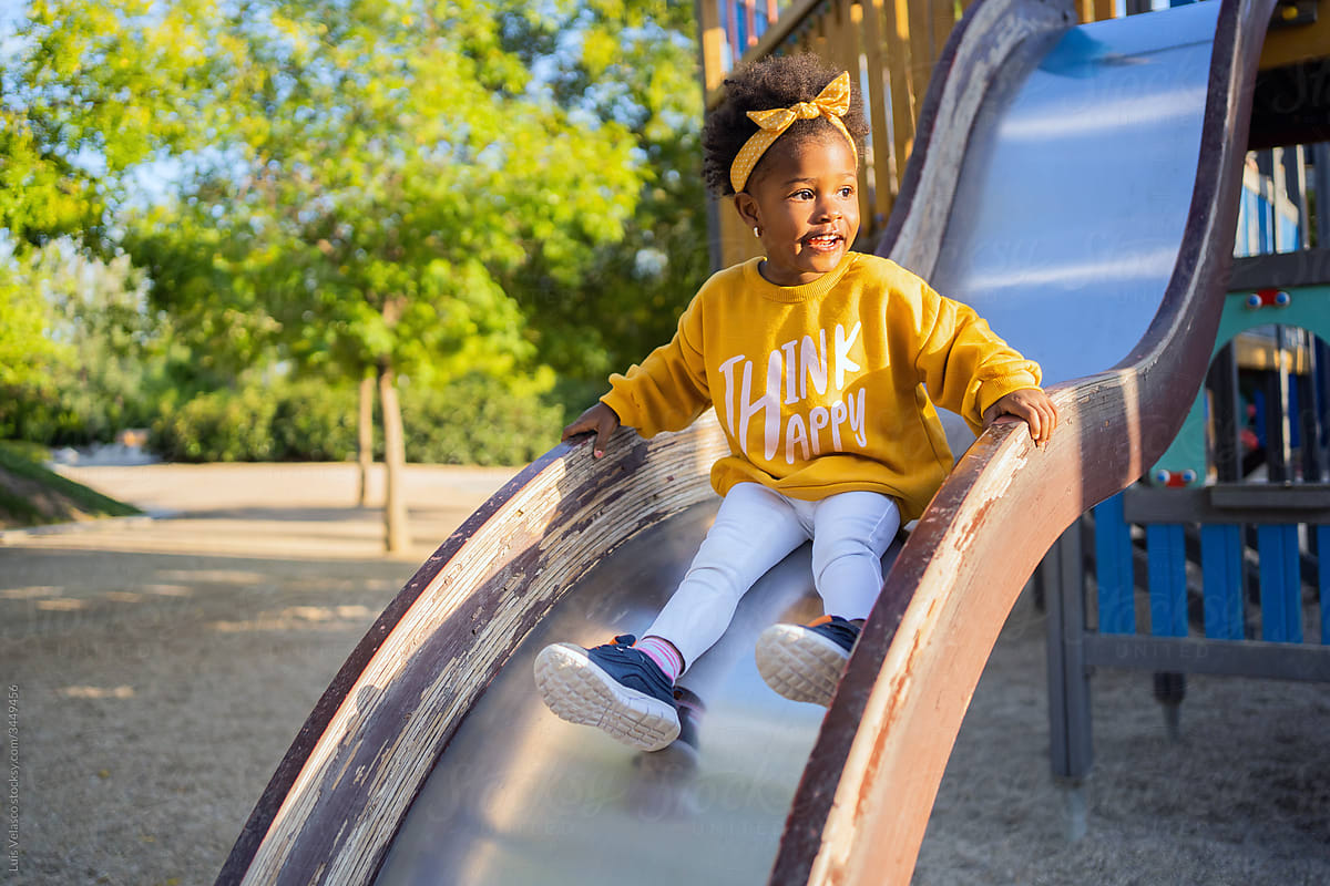 Little Black Girl In The Slide Of The Play Area.