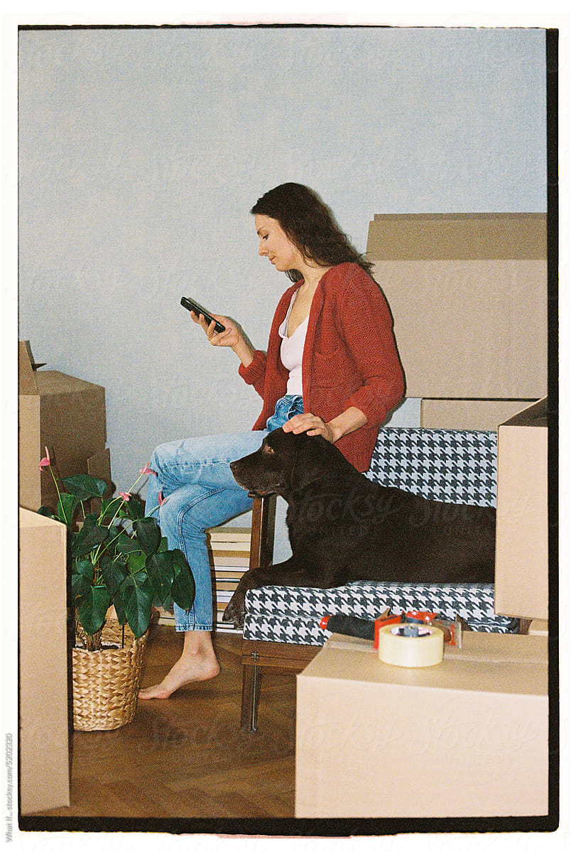 A woman and a dog among the things to move.
