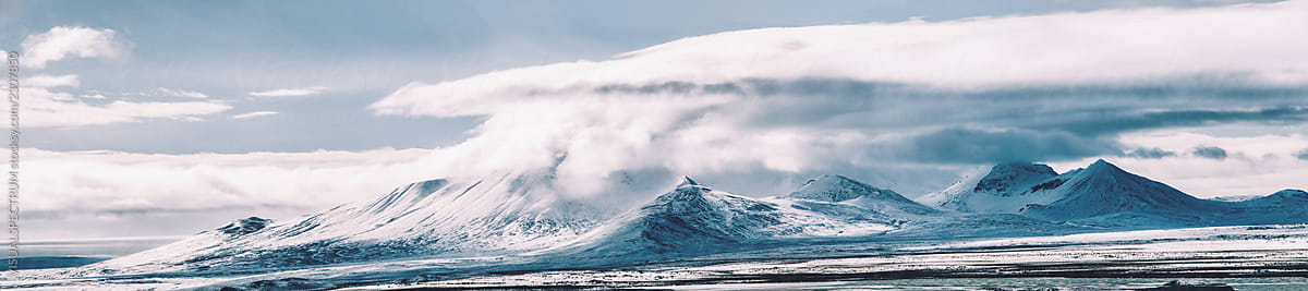 Massive Cloud Formation Surrounding Peak in Sunny Highlands of Iceland