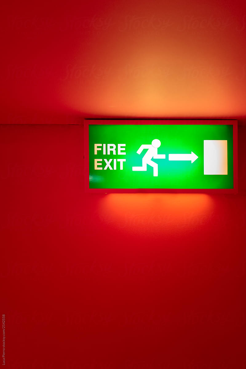 Fire exit sign on a red wall