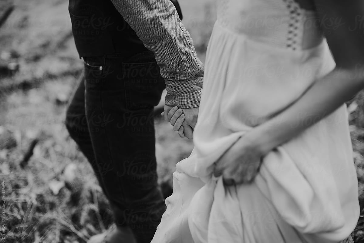 Lovers On Their Elopement In Yosemite Holding Hands And Exploring By