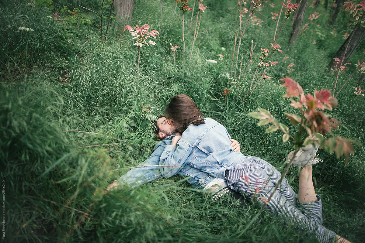 Young Couple Lying On A Grass By Stocksy Contributor Yurii