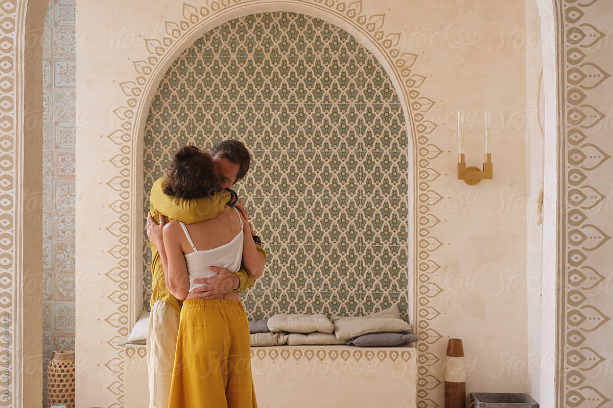Man hugging woman in Arabic room