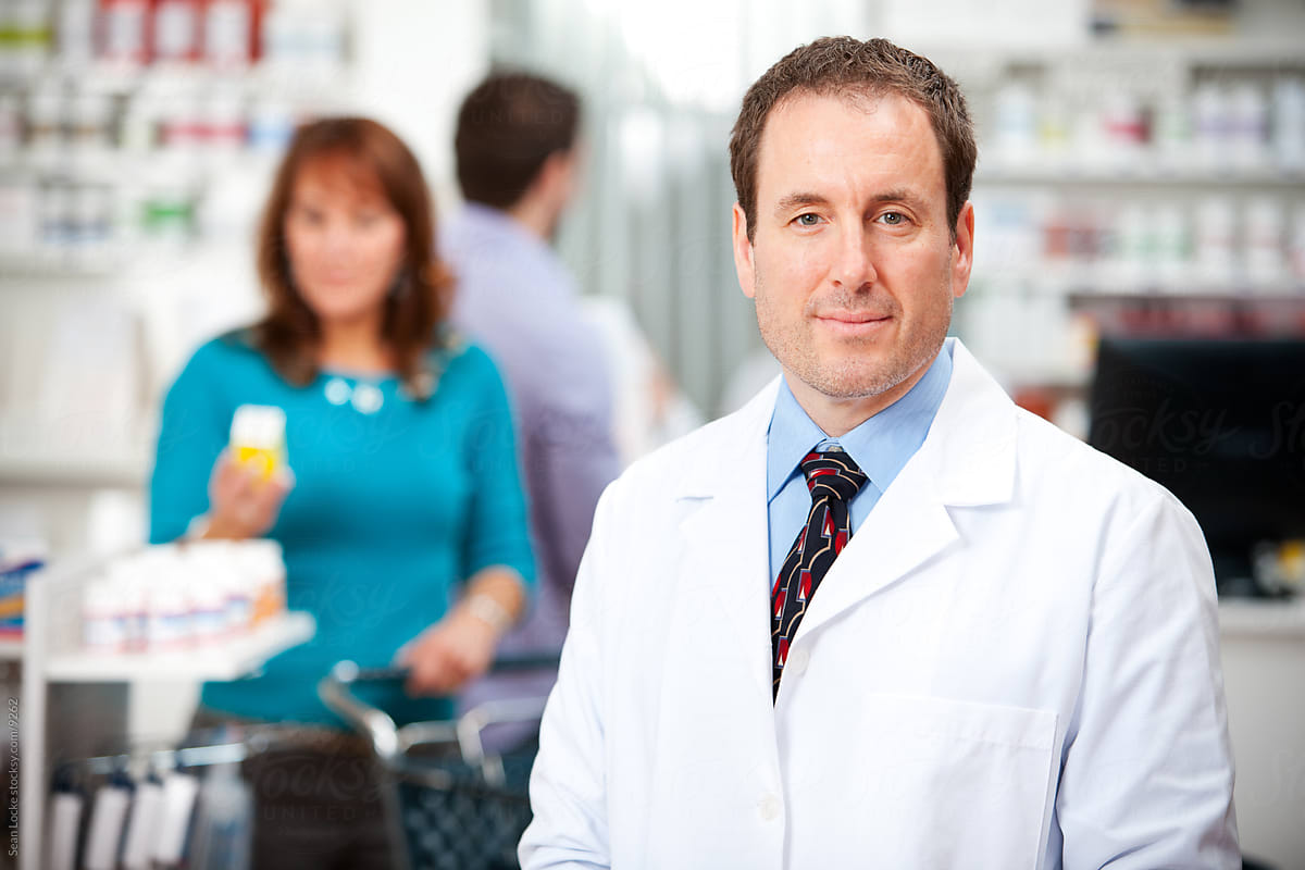 Pharmacy: Professional Pharmacist with Shoppers in Background