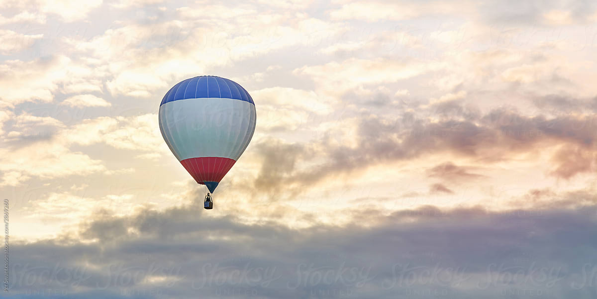 Hot air balloon raising with beautiful morning sky