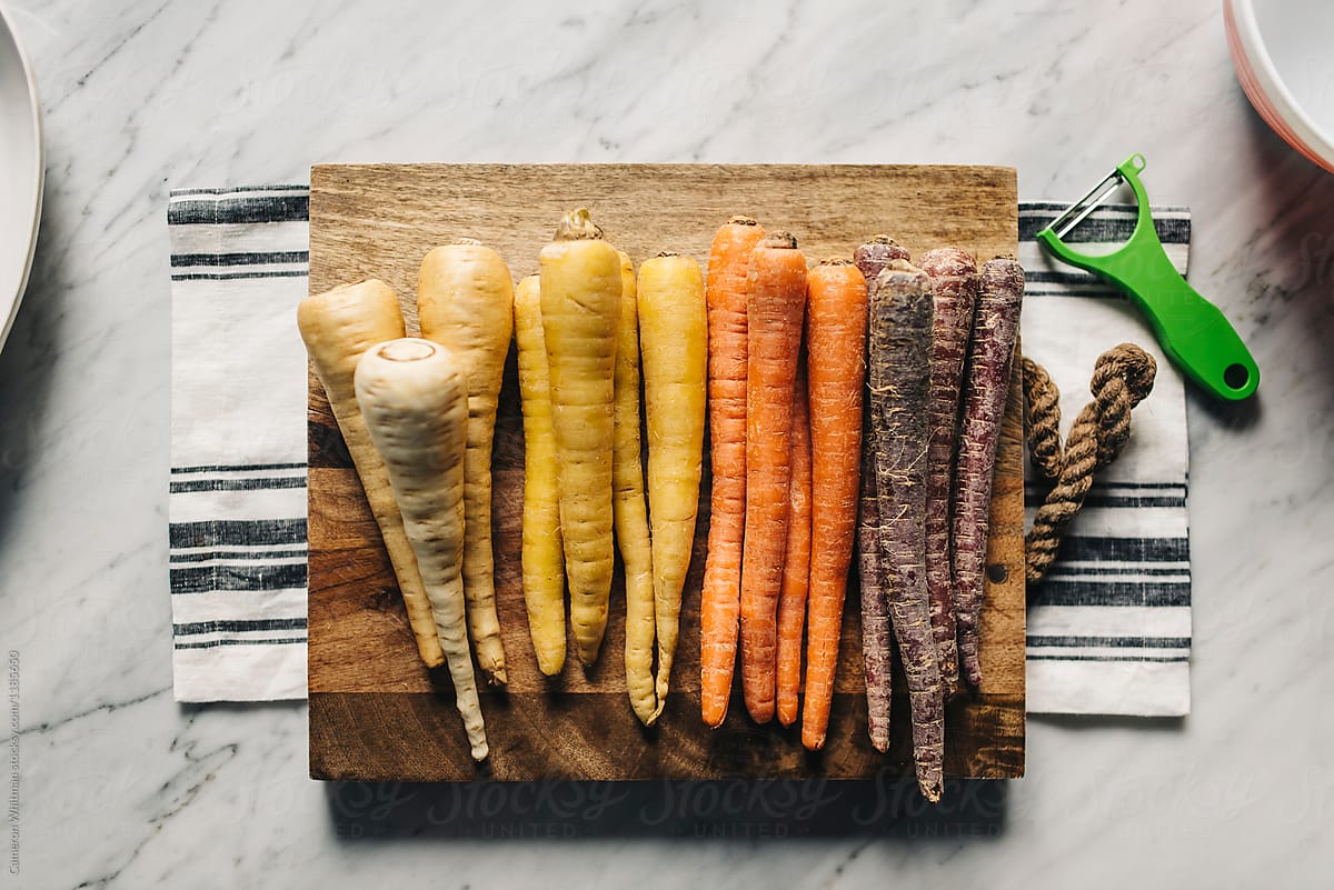 A row of multicolored carrots and parsnips