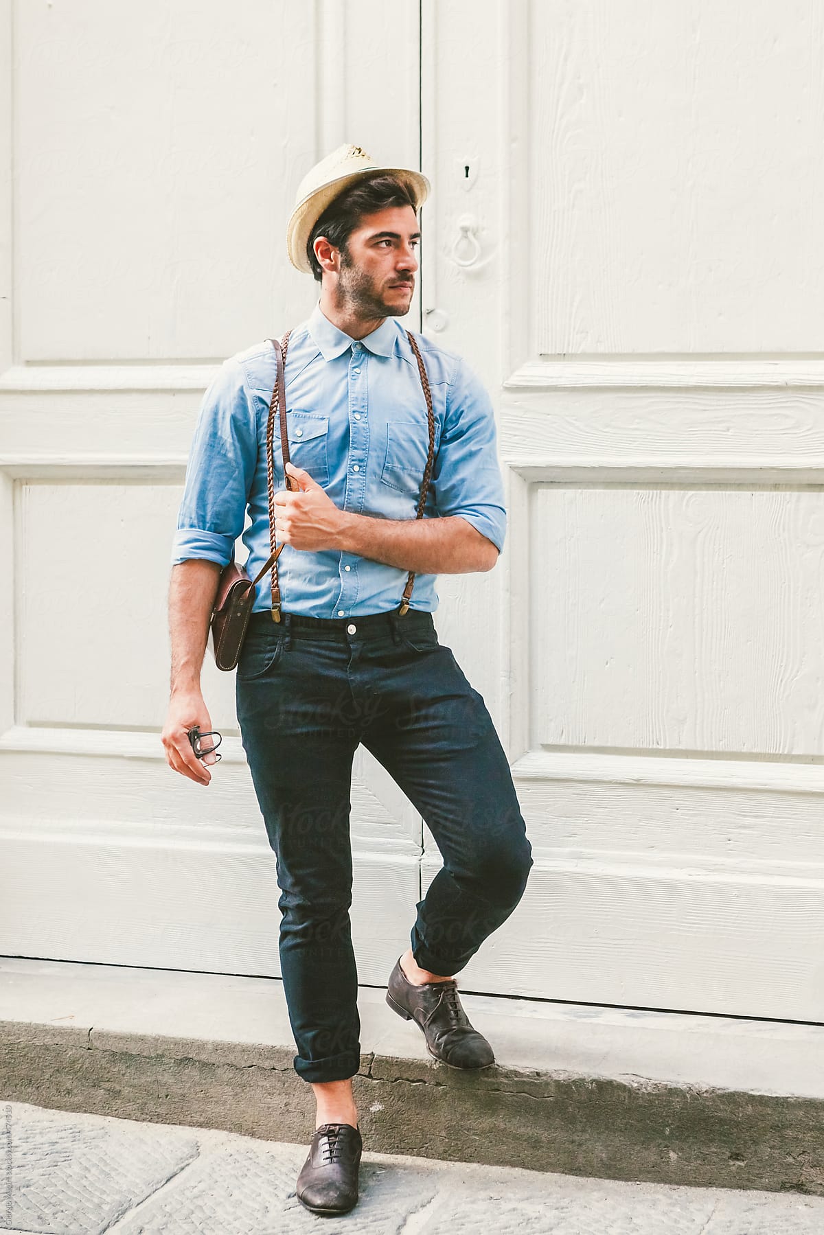 Handsome Hipster Man in front of a White Wooden Door