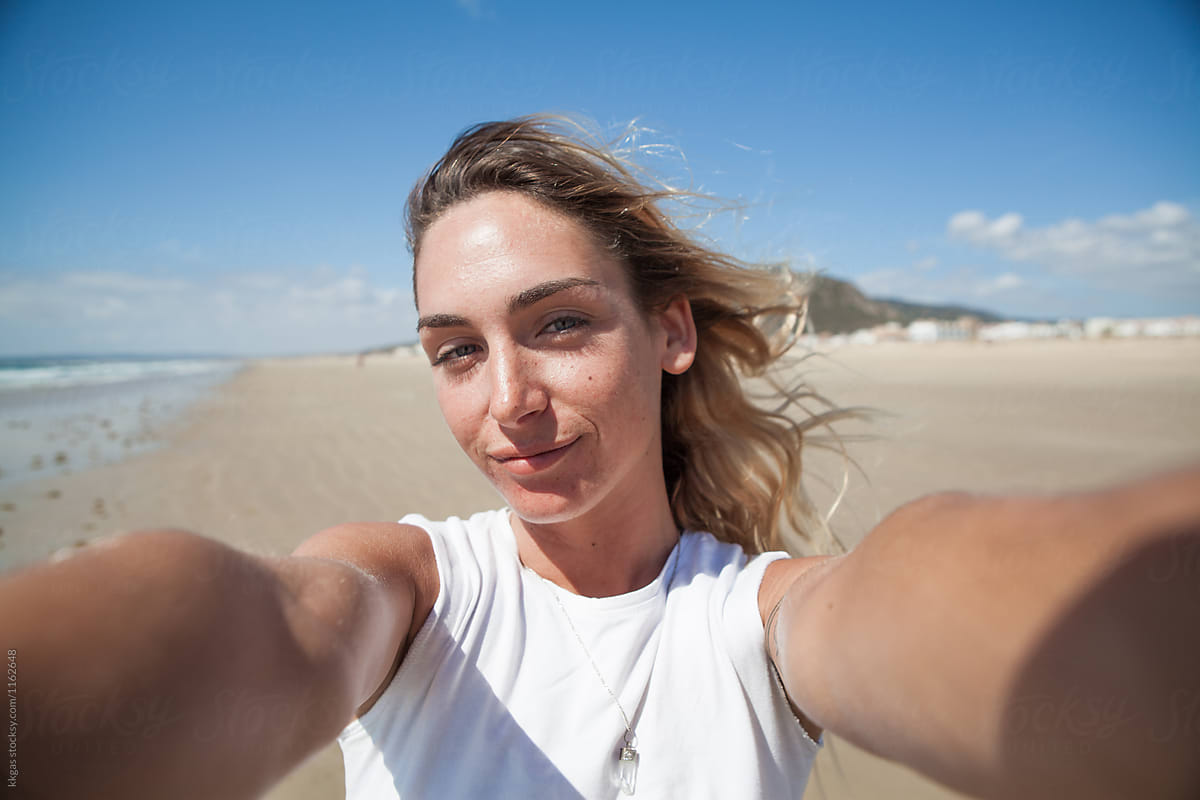 Selfie Of A Beautiful Blonde Woman Walking On The Beach Stocksy United 