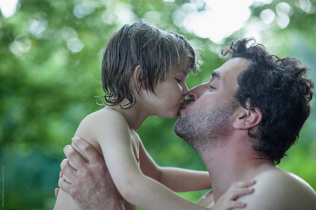 Father and son kissing