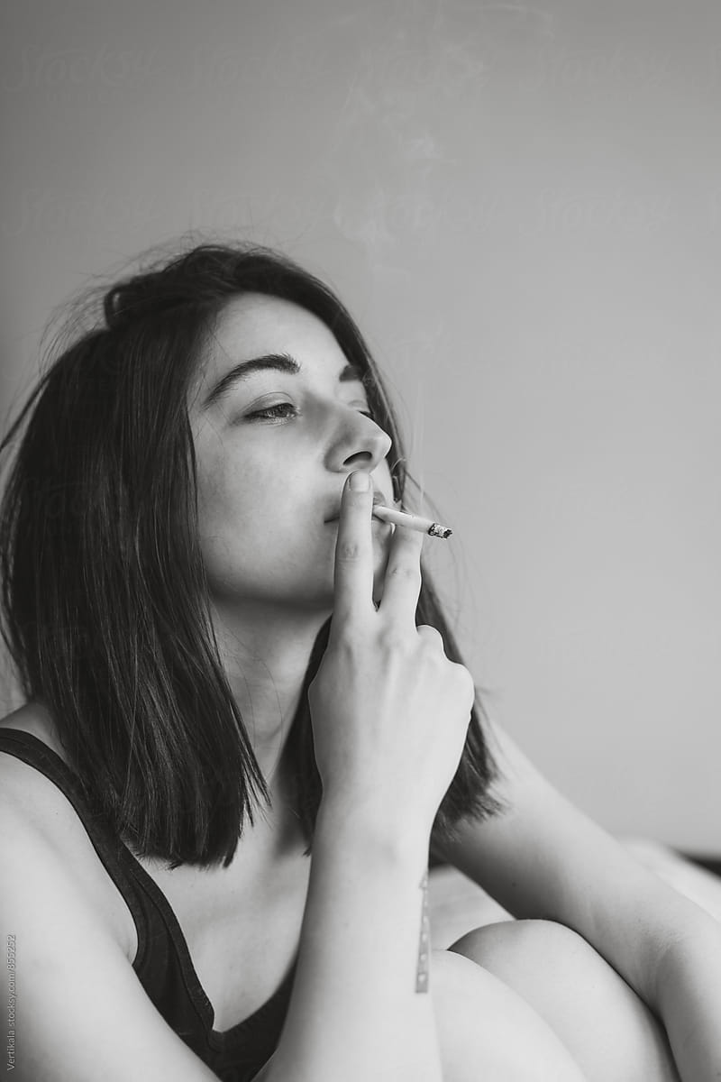 Attractive woman smoking a cigarette indoor
