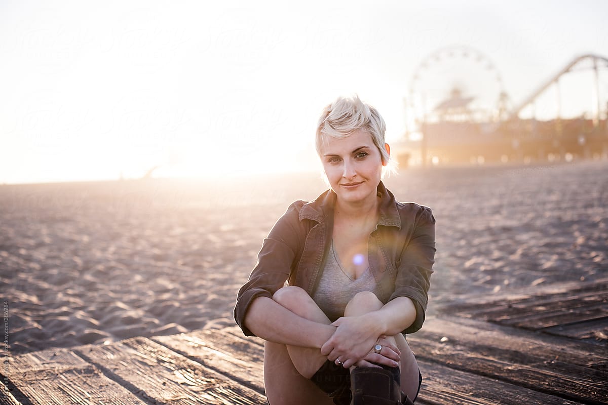 Blonde woman sitting on the beach