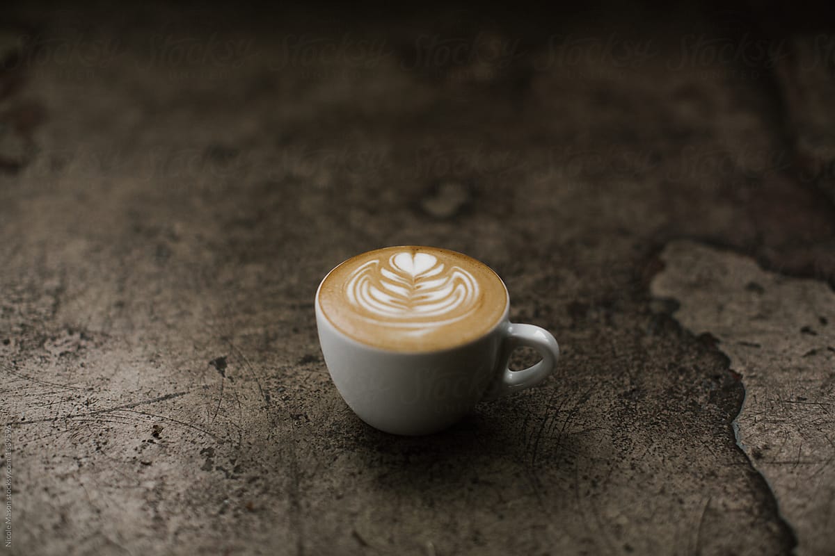 latte art in mug on concrete surface