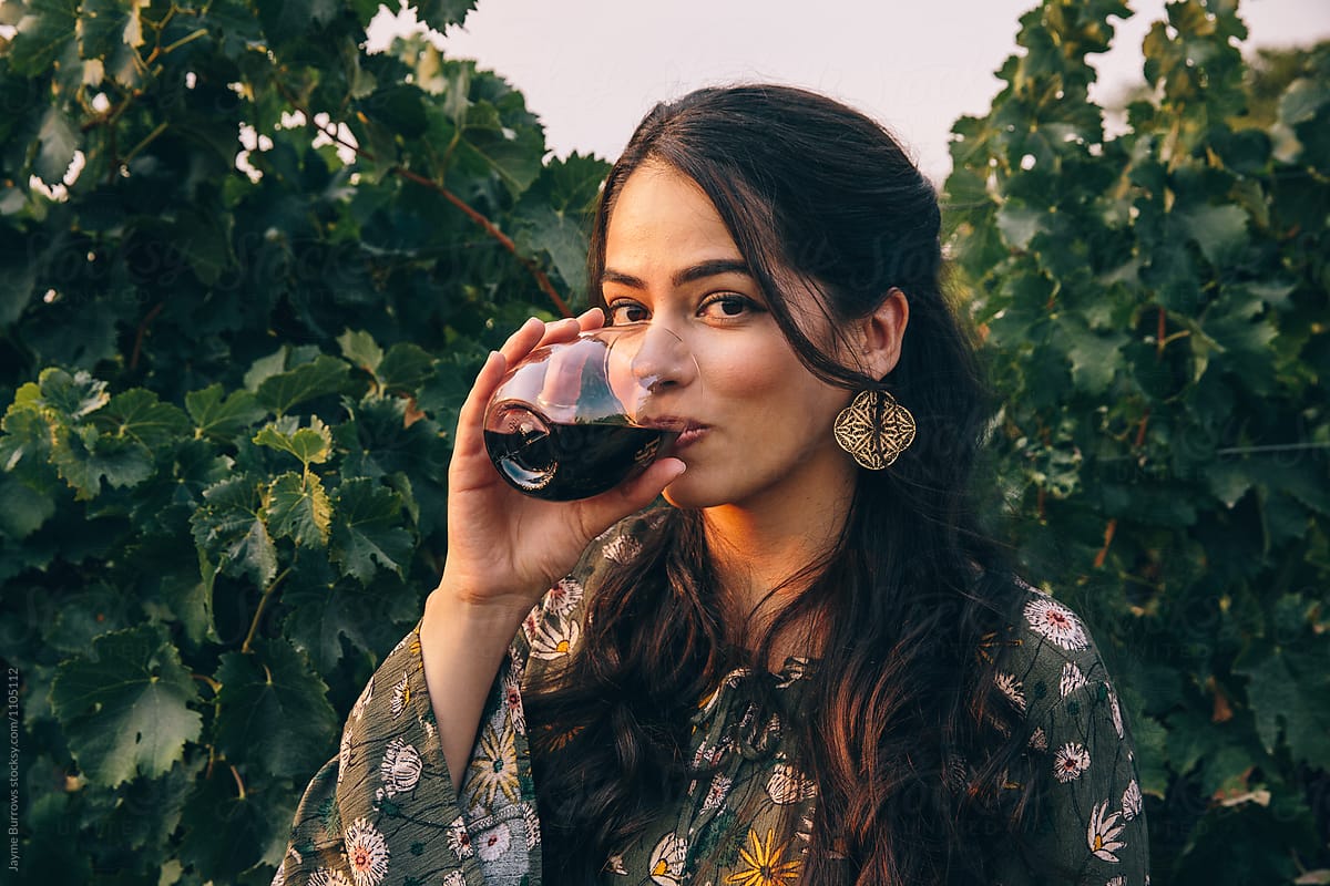 Pretty Latina Woman Drinking Wine By Stocksy Contributor Jayme 
