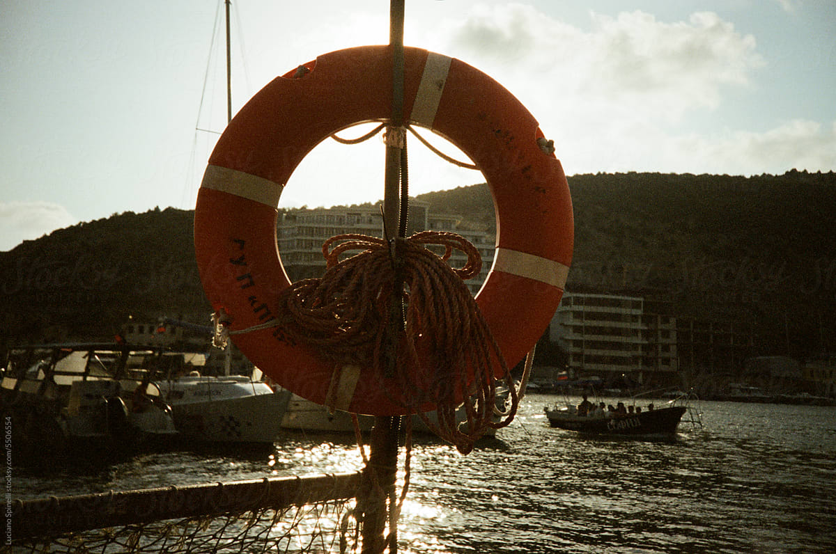Vintage life buoy in Harbor - boats and the sea in the background