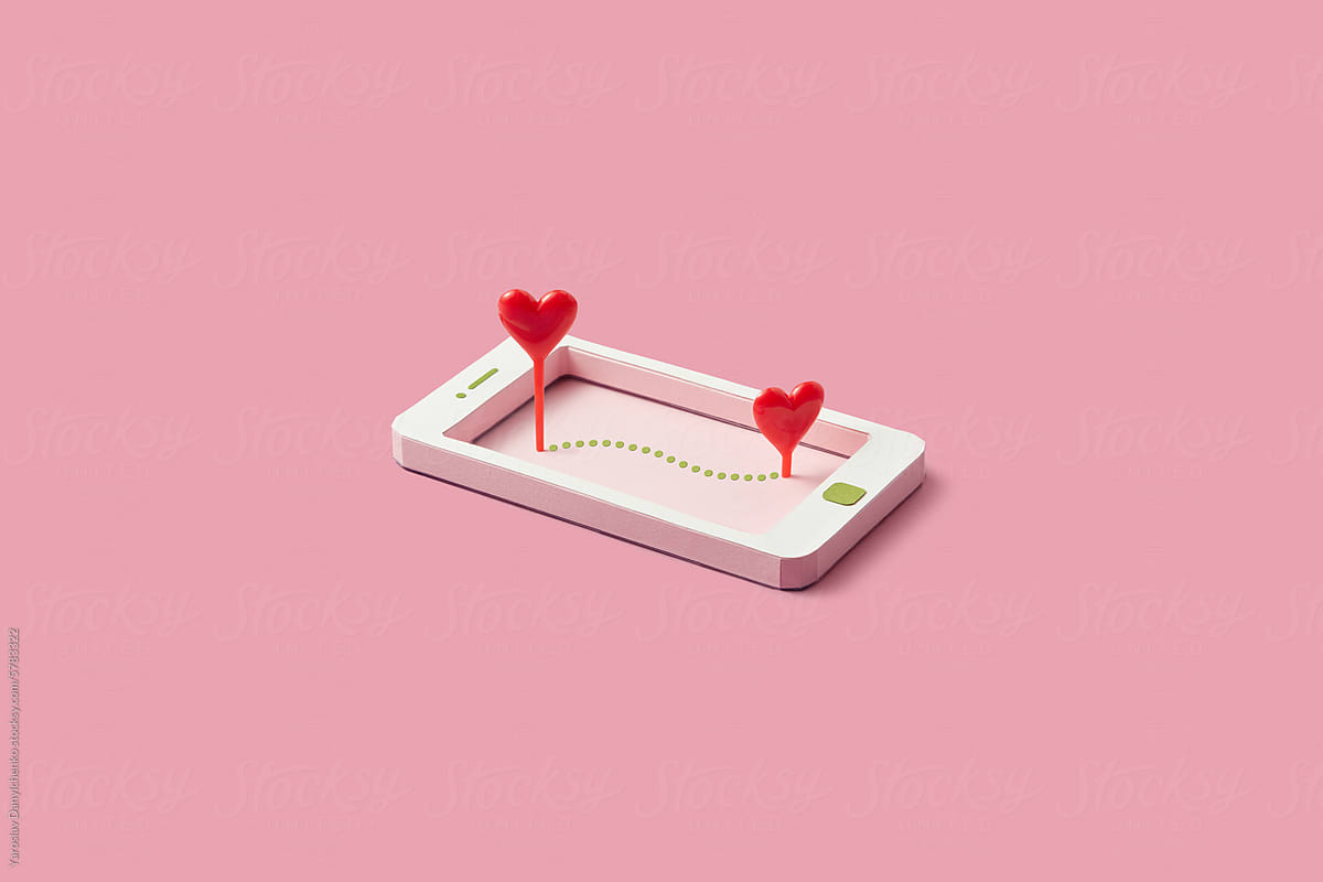 Colorful papercraft smartphone with two red hearts on screen