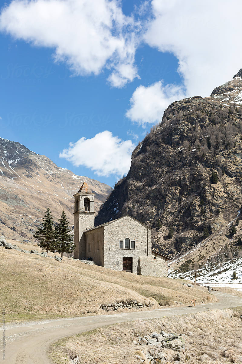 old stone church with mountainous landscape
