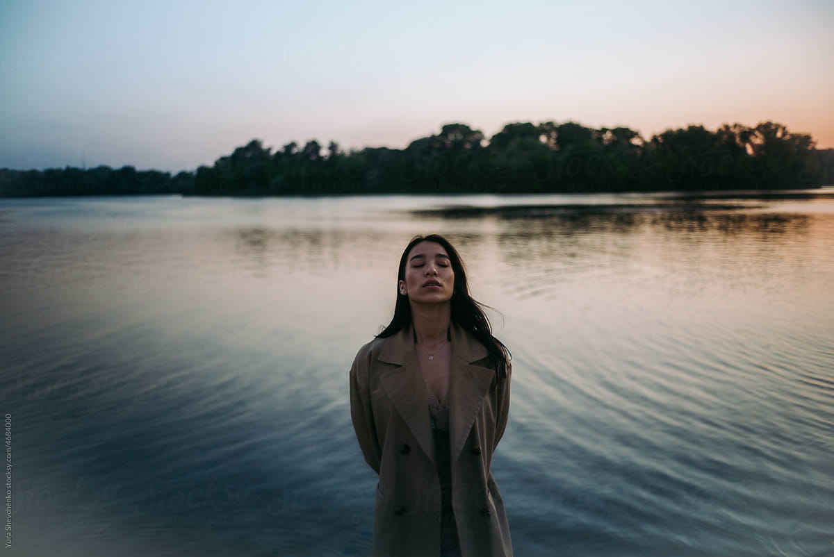 portrait of a young asian woman on a lake shore