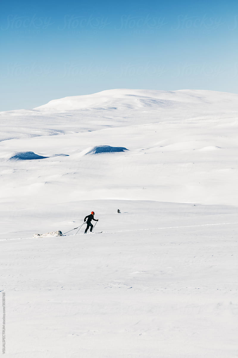 Backcountry Skier Pulling Cargo Sled Uphill
