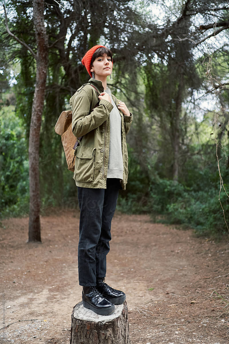 Female traveler standing in forest