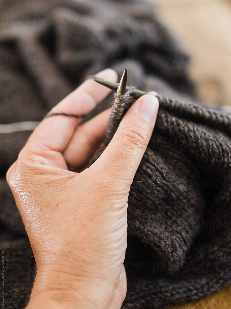 hand holding knitting in progress