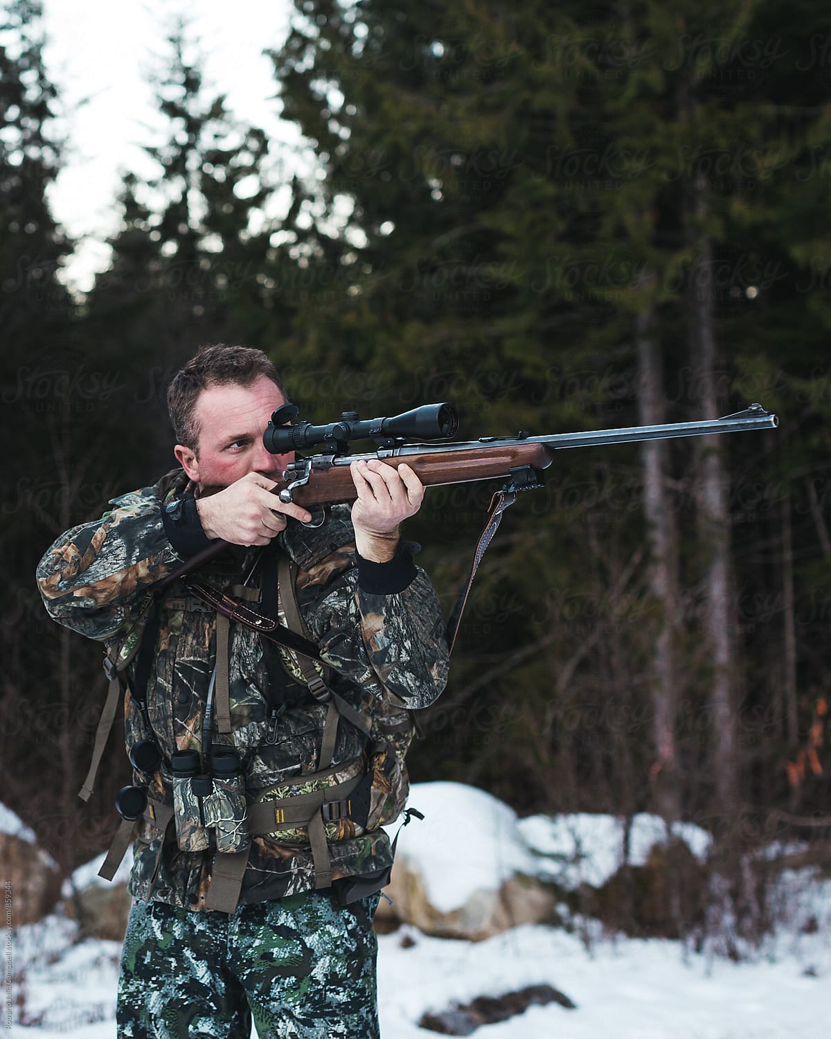 Hunter taking aim with rifle