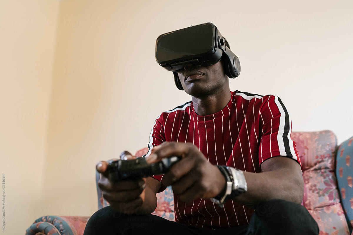 Black man playing VR videogame