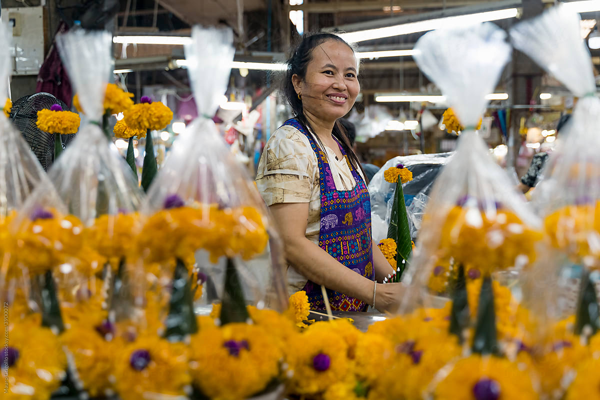 Smiling Asian woman at the flower market