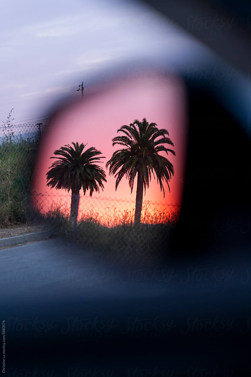 Pretty sunset view through car mirror