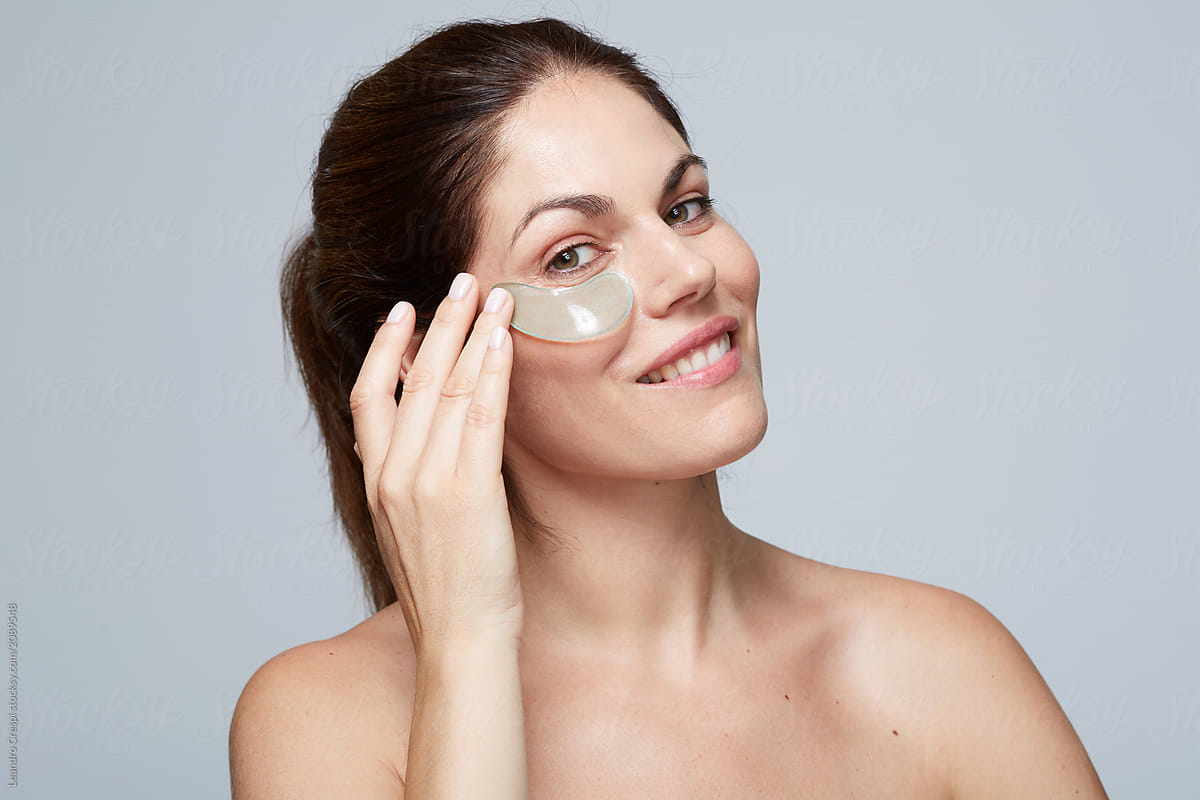 Woman using gel eye patch mask