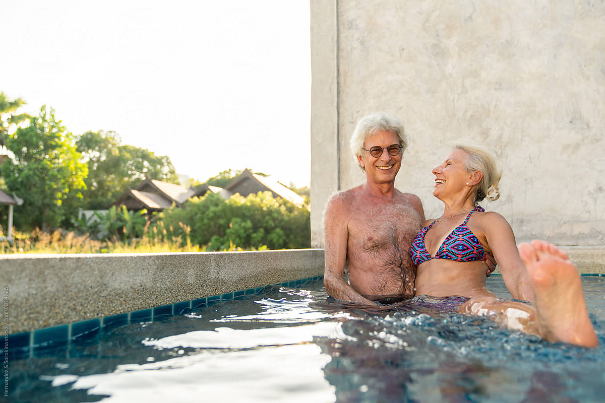 Cheerful Senior Couple Having Fun In The Pool