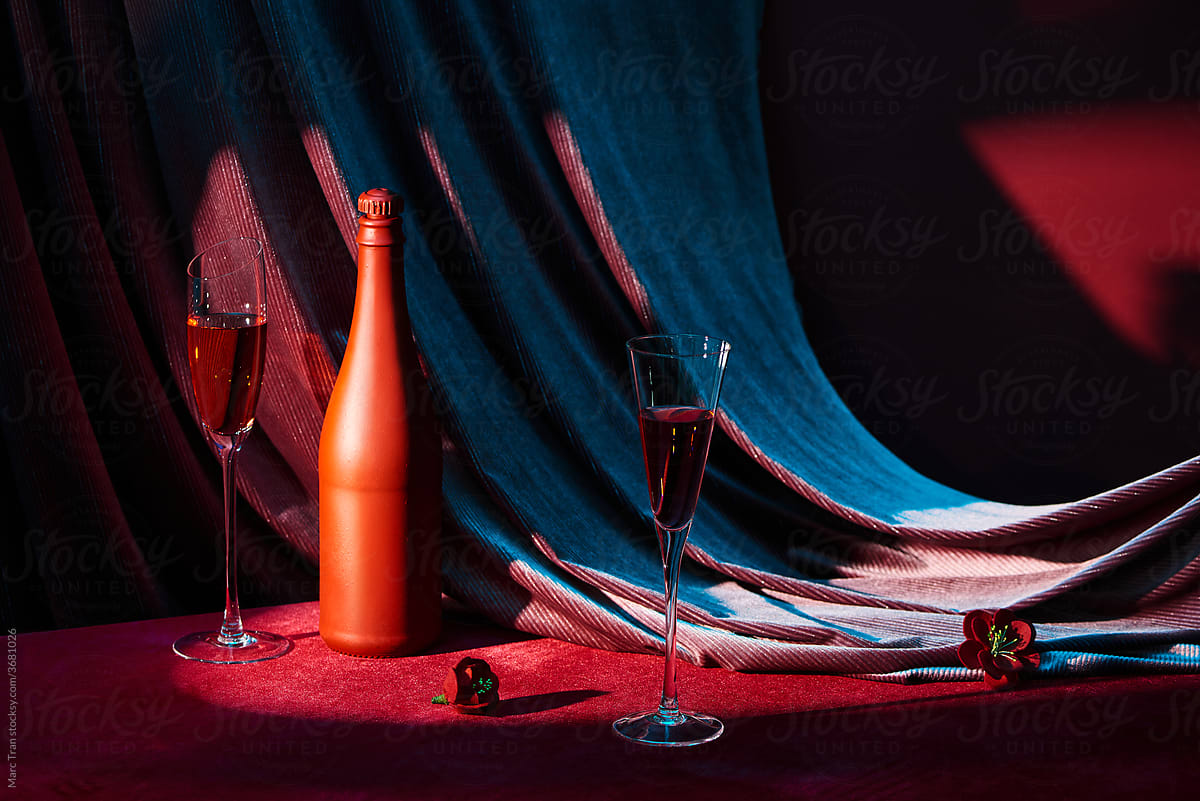Wineglass and bottle of wine on a reflective background