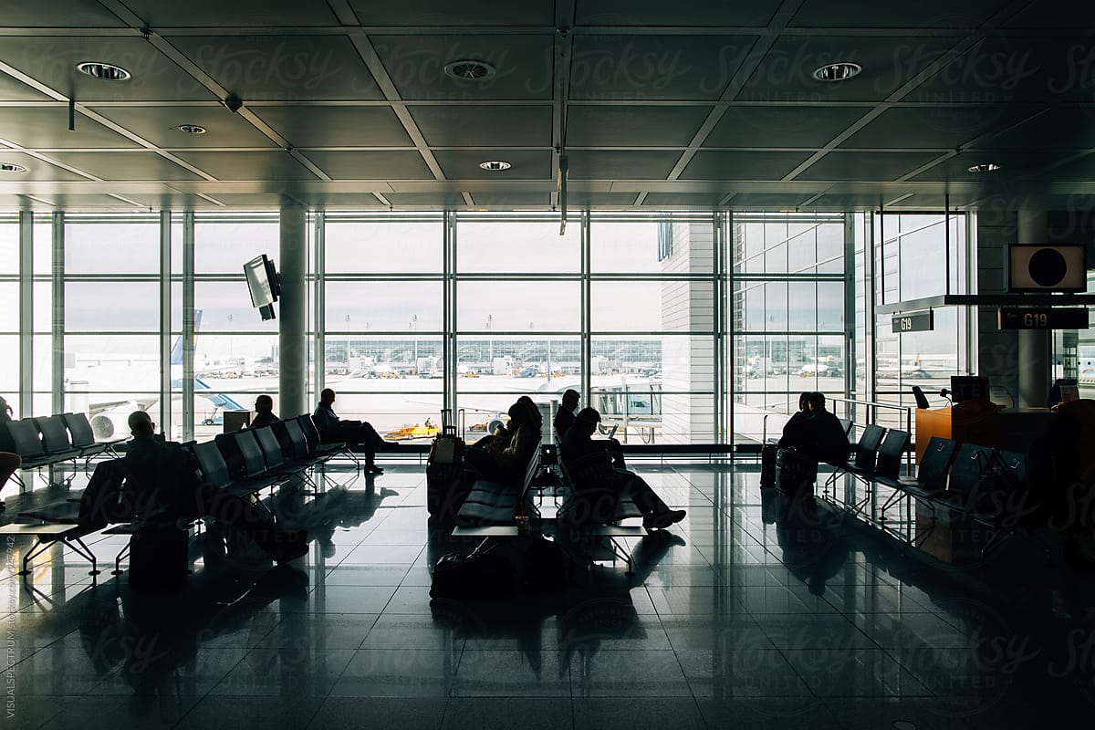 Silhouette of Passengers Waiting To Board Plane in Modern Airport
